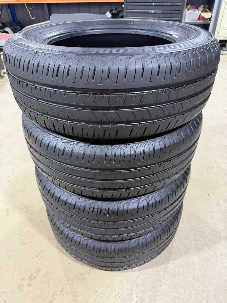 A matched set of four used tyres stacked in the Auswide Tyres workshop