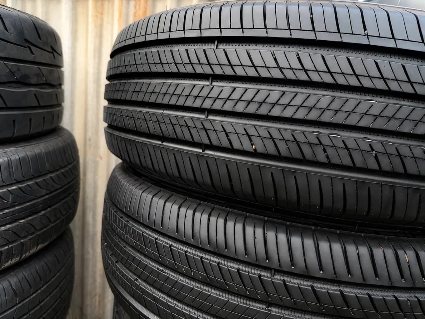 Close-up of the tread on used tyres stacked at the Auswide Tyres workshop